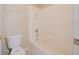 Bathroom featuring a toilet and a tub with a shower at 2142 Brandywine Falls Way, Orlando, FL 32824