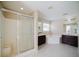Spacious bathroom features a shower, soaking tub, and double sink with dark cabinets at 2142 Brandywine Falls Way, Orlando, FL 32824