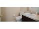Cozy bathroom featuring a sink with dark cabinets and a toilet at 2142 Brandywine Falls Way, Orlando, FL 32824