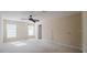 Spacious bedroom with neutral carpet, ceiling fan, and natural light from multiple windows at 2142 Brandywine Falls Way, Orlando, FL 32824