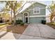 Traditional two-story home boasts a manicured front yard and a two car garage at 2142 Brandywine Falls Way, Orlando, FL 32824