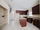 Kitchen boasts dark cabinets, a convenient island, and modern appliances at 2142 Brandywine Falls Way, Orlando, FL 32824