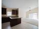 Open kitchen layout with island, dark wood cabinets, and sliding glass doors to the backyard at 2142 Brandywine Falls Way, Orlando, FL 32824