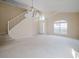 Bright open-concept living space featuring high ceilings and a staircase at 2142 Brandywine Falls Way, Orlando, FL 32824