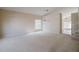 Open-concept living room with plush carpeting and abundant natural light at 2142 Brandywine Falls Way, Orlando, FL 32824