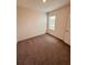 Comfortable bedroom with neutral carpeting and a bright window at 3460 Sandalwood Isle Way, Ocoee, FL 34761