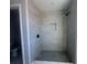 Modern bathroom shower stall featuring neutral tiles and a matte black shower head at 1165 Basalt Ln, Sanford, FL 32771