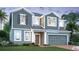 Charming two-story home featuring a well-manicured lawn and attached two car garage at 1165 Basalt Ln, Sanford, FL 32771