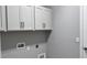 White cabinets in the laundry room providing ample storage space at 1165 Basalt Ln, Sanford, FL 32771