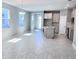 Open concept living area with tiled floors connecting the kitchen, dining and living room at 1165 Basalt Ln, Sanford, FL 32771
