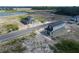 Aerial shot of newly built homes in a developing community, with a pond nearby at 1360 Lumpini St, St Cloud, FL 34771