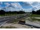 Community entrance with a modern sign, newly planted trees, and paved walking and driving paths at 1360 Lumpini St, St Cloud, FL 34771
