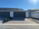 Modern townhome exterior with a two-car garage and a well-maintained brick driveway at 1360 Lumpini St, St Cloud, FL 34771
