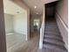 Entryway featuring stairs with carpet and a view of the kitchen and living room at 1360 Lumpini St, St Cloud, FL 34771