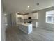 Bright kitchen featuring white cabinets, stainless steel appliances, and a kitchen island at 1360 Lumpini St, St Cloud, FL 34771