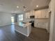 Spacious kitchen featuring an island with white cabinets, stone countertops, and stainless steel appliances at 1364 Lumpini St, St Cloud, FL 34771