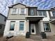 Two-story house with gray and beige siding, white shutters, and a covered front porch at 1384 Lumpini St, St Cloud, FL 34771