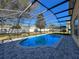 Screened-in pool area with brick pavers and an open view of the backyard, ideal for outdoor enjoyment at 2387 Laurel Blossom Cir, Ocoee, FL 34761