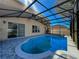 Inviting screened-in pool with paved deck, offering a private outdoor retreat on a sunny day at 2387 Laurel Blossom Cir, Ocoee, FL 34761