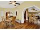 Dining area with hardwood floors, wooden table and chairs, and view into kitchen at 1007 Tony Cir, St Cloud, FL 34772