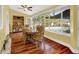 Sunlit dining room with hardwood floors, wooden table and chairs, and pool view at 1007 Tony Cir, St Cloud, FL 34772