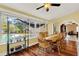 Bright dining room with hardwood floors, wooden table and chairs, and sunroom access at 1007 Tony Cir, St Cloud, FL 34772