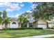 One-story house with brick facade, mature landscaping, and a two-car garage at 1007 Tony Cir, St Cloud, FL 34772