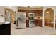 Kitchen with stainless steel appliances, dark wood cabinets and tile floor at 1007 Tony Cir, St Cloud, FL 34772