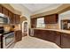 Kitchen with dark wood cabinets, stainless steel appliances, and tile floors at 1007 Tony Cir, St Cloud, FL 34772