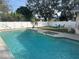 Inviting rectangular pool with a spa and a white vinyl fence at 1007 Tony Cir, St Cloud, FL 34772
