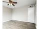 An interior shot of a bedroom with gray walls, gray wood-look flooring, and a ceiling fan at 5417 Fairwood Way # 304, Orlando, FL 32808