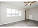 An interior shot of a bedroom with gray walls, gray wood-look flooring, and a window at 5417 Fairwood Way # 304, Orlando, FL 32808