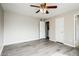 Bedroom with wood-look flooring and access to the ensuite bathroom and closet at 5417 Fairwood Way # 304, Orlando, FL 32808