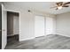An interior shot of a bedroom with gray walls, gray wood-look flooring, and two closets at 5417 Fairwood Way # 304, Orlando, FL 32808