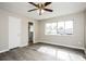 Bright bedroom with wood-look flooring and views of the ensuite bathroom at 5417 Fairwood Way # 304, Orlando, FL 32808