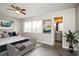 Bright bedroom with a ceiling fan, a large window, and a view into the bathroom at 5417 Fairwood Way # 304, Orlando, FL 32808