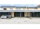 Exterior townhome complex featuring assigned covered parking with painted numbers above each carport at 5417 Fairwood Way # 304, Orlando, FL 32808