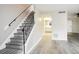 Hallway with a view into the kitchen, staircase, and modern flooring at 5417 Fairwood Way # 304, Orlando, FL 32808