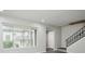 Bright living room showcasing a staircase and a view to the outside at 5417 Fairwood Way # 304, Orlando, FL 32808