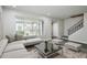 Modern living room featuring a stylish sofa, contemporary coffee table, and staircase at 5417 Fairwood Way # 304, Orlando, FL 32808