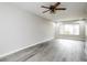 Bright living room featuring a ceiling fan and a large window at 5417 Fairwood Way # 304, Orlando, FL 32808