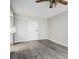 Bright living room area with gray wood-look flooring and white doors at 5417 Fairwood Way # 304, Orlando, FL 32808