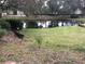 Peaceful backyard with pond view and lush green grass at 474 S Pin Oak Pl # 108, Longwood, FL 32779