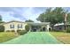 Charming single-story home featuring a covered carport and well-maintained lawn at 6604 Scenic Point Se Dr, Winter Haven, FL 33884