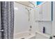 Clean bathroom with shower/tub combo, white cabinets, and patterned shower curtain at 7900 S Orange Blossom Trl # 2097, Orlando, FL 32809