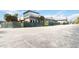 View of exterior showing building under construction with secure fencing and large parking area at 7900 S Orange Blossom Trl # 2097, Orlando, FL 32809