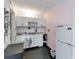 Compact kitchen with white cabinets and appliances at 7900 S Orange Blossom Trl # 2097, Orlando, FL 32809