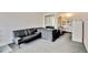 Small living room with sofa and kitchenette view at 7900 S Orange Blossom Trl # 2097, Orlando, FL 32809