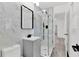 Chic bathroom featuring marble tile, a glass-enclosed shower, and a modern vanity at 245 W George Ave, Maitland, FL 32751
