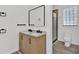 Bright bathroom featuring a double sink vanity, neutral decor, glass block window, and walk-in shower at 245 W George Ave, Maitland, FL 32751